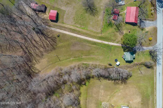 a living room with furniture a rug and a floor to ceiling window
