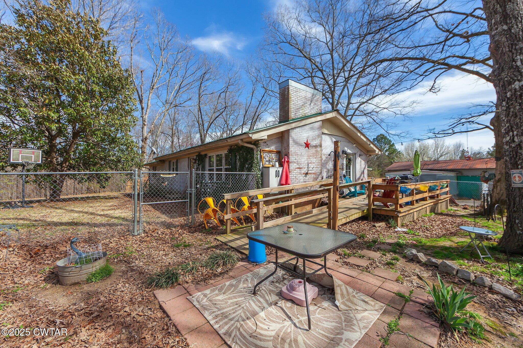 196 Pierce Road Beech Bluff, TN 38313 - Photo 42 of 63 a roof deck with table and chairs and potted plants