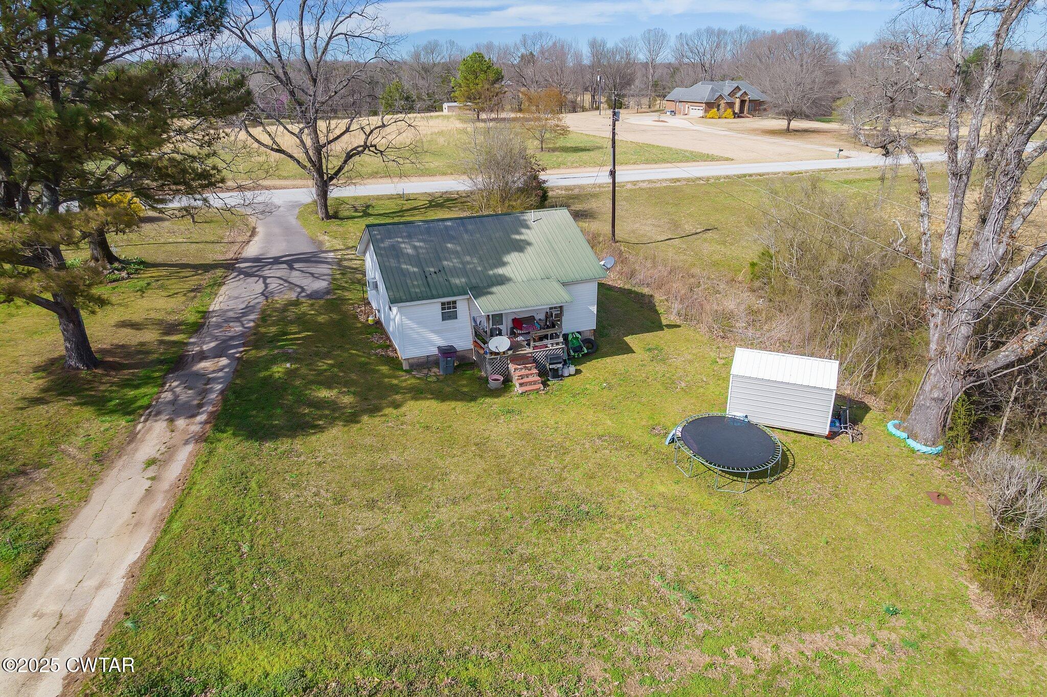 196 Pierce Road Beech Bluff, TN 38313 - Photo 58 of 63 a swimming pool with some trees in the background