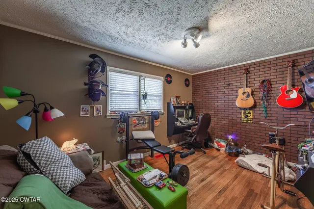a bedroom with a bed and a bookshelf with wooden floor