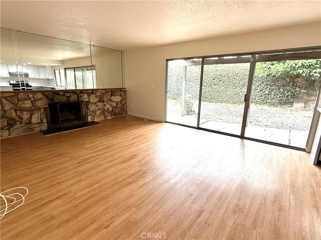 a view of a room with wooden floor