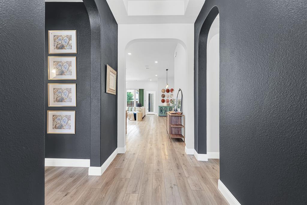 6404 Trezevant Street Rowlett, TX 75089 - Photo 4 of 30 a view of a hallway with wooden floor and a living room