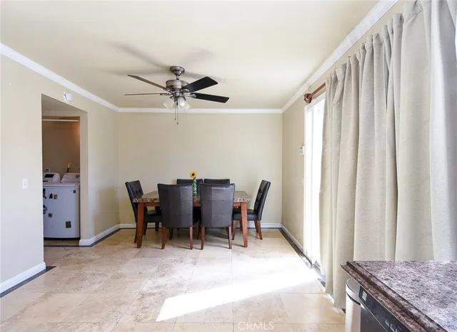 a view of a dining room with furniture and a window