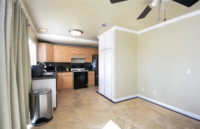 a kitchen with a refrigerator and a stove