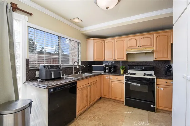 a kitchen with a sink stove and cabinets