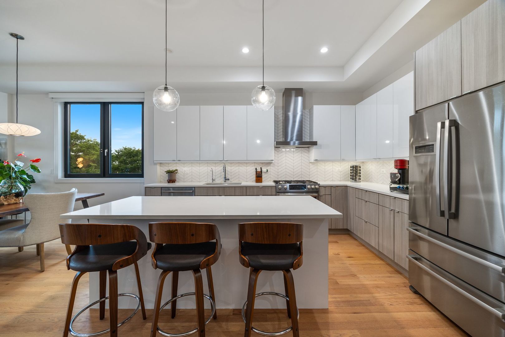 2116 West Chicago Avenue, Unit 3W Chicago, IL 60622 - Photo 11 of 37 a kitchen with stainless steel appliances granite countertop a sink a stove a refrigerator and chairs