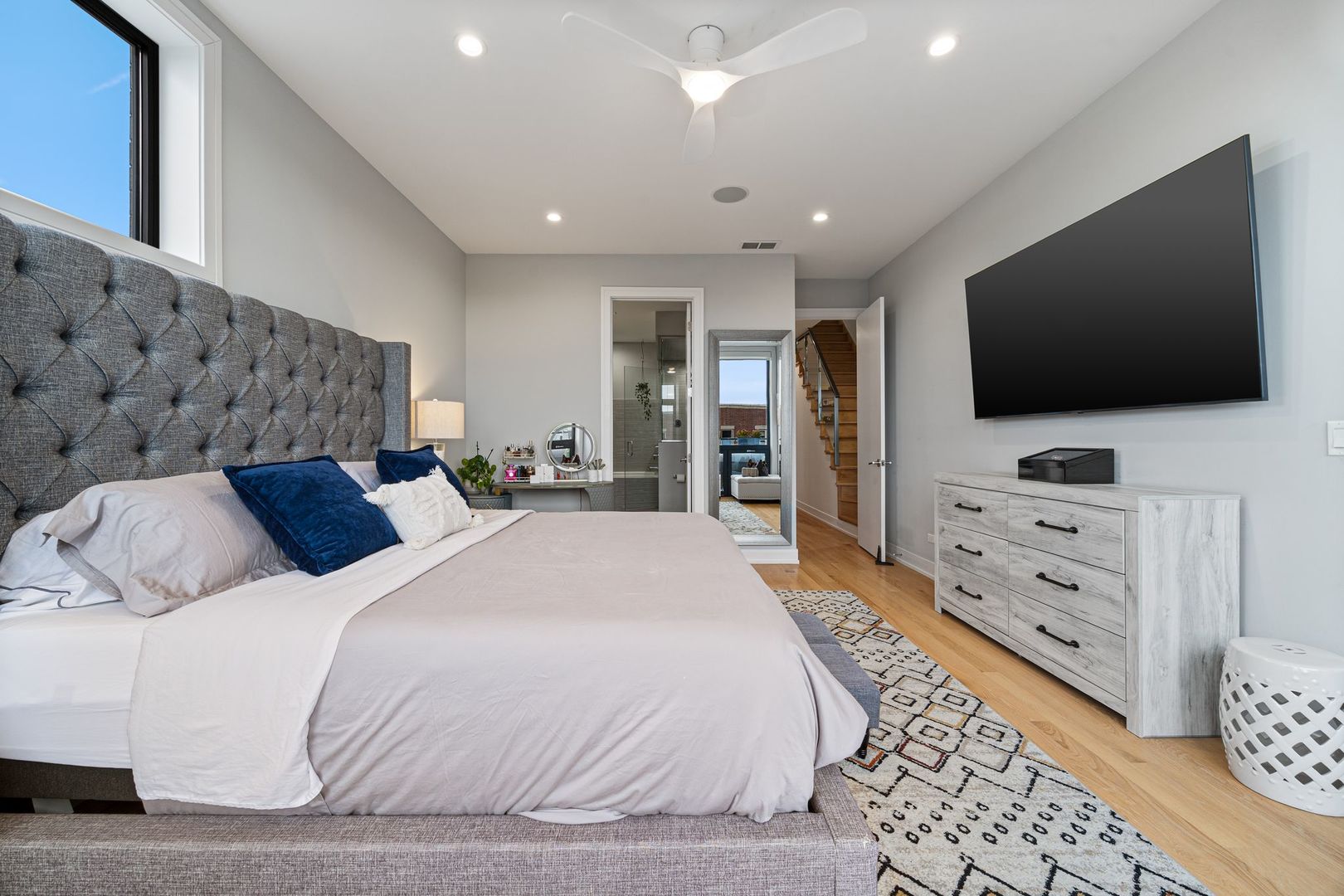 2116 West Chicago Avenue, Unit 3W Chicago, IL 60622 - Photo 19 of 37 a bedroom with a large bed and a flat screen tv on dresser