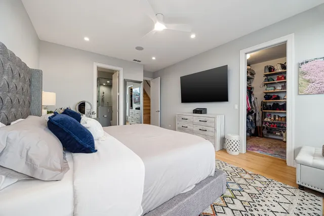 a view of walk in closet with clothes and shoes