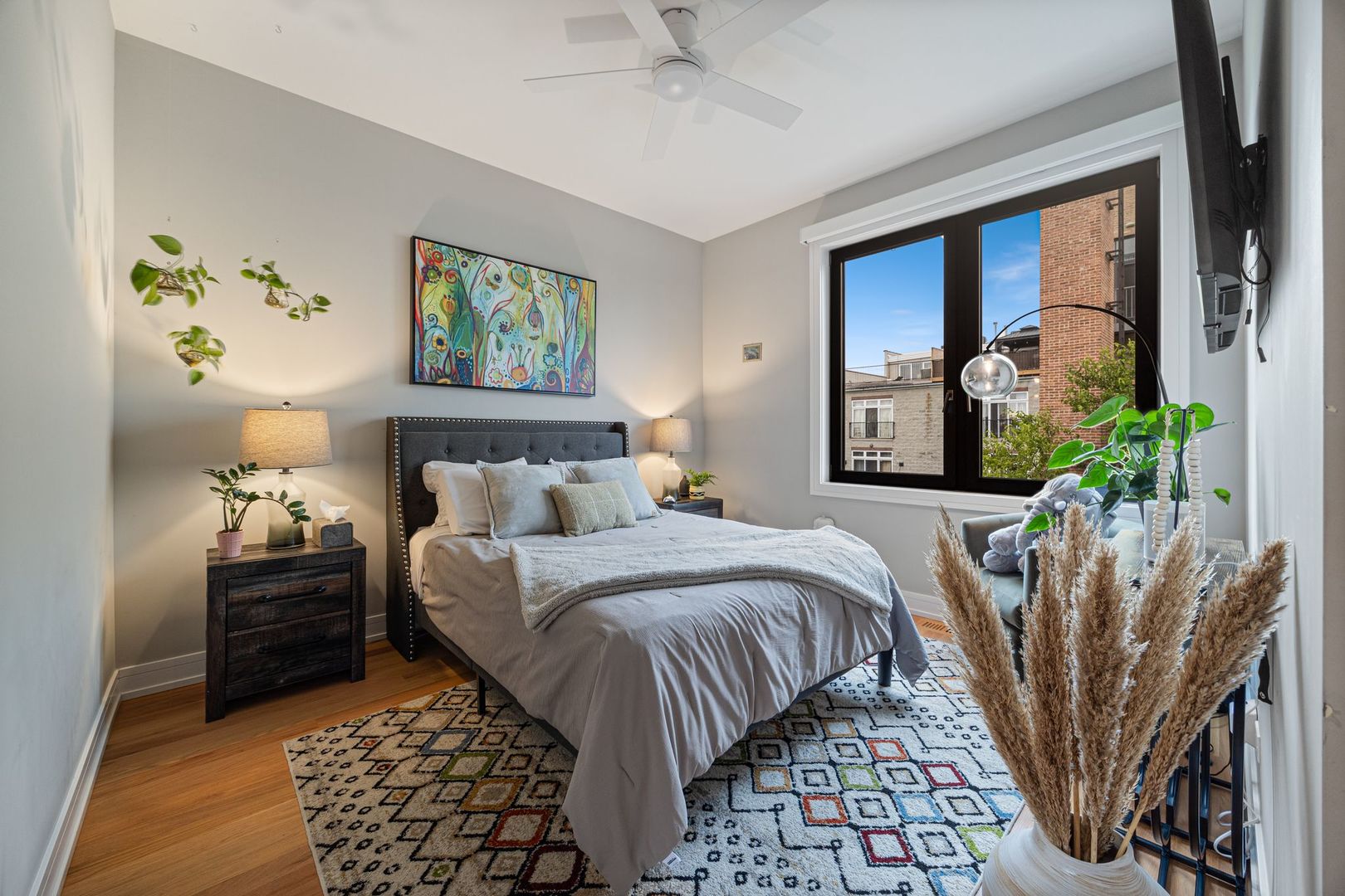 2116 West Chicago Avenue, Unit 3W Chicago, IL 60622 - Photo 28 of 37 a bedroom with a large bed and a potted plant