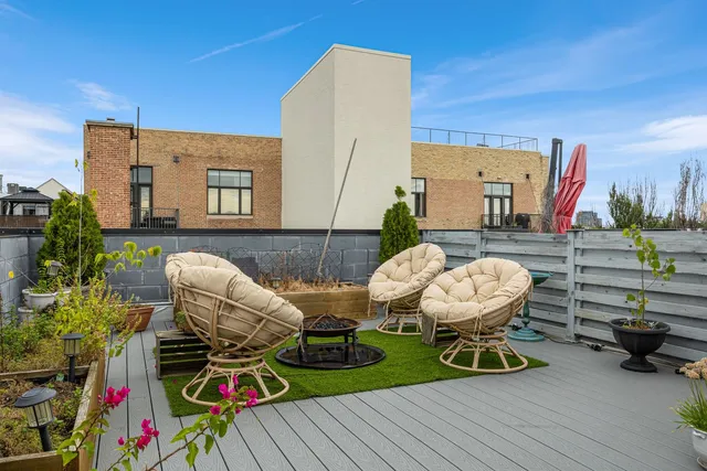 a roof deck with patio and outdoor seating
