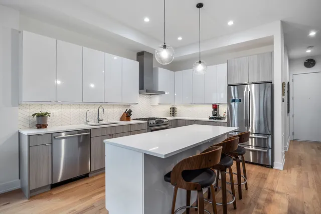 a kitchen with cabinets appliances and a sink