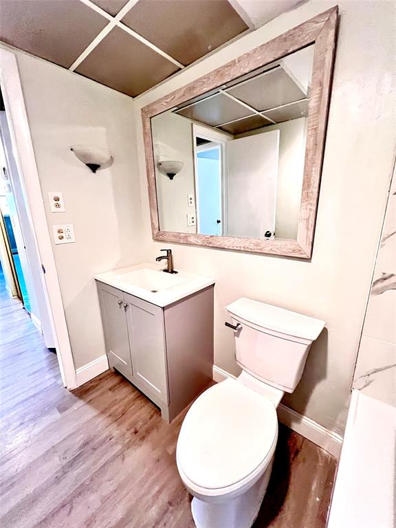 7000 Northwest 17th Street, Unit 109 Plantation, FL 33313 - Photo 17 of 21 a bathroom with a toilet a sink and a mirror