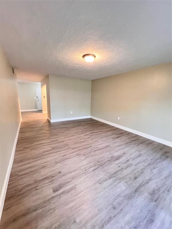7000 Northwest 17th Street, Unit 109 Plantation, FL 33313 - Photo 4 of 21 a view of an empty room with wooden floor