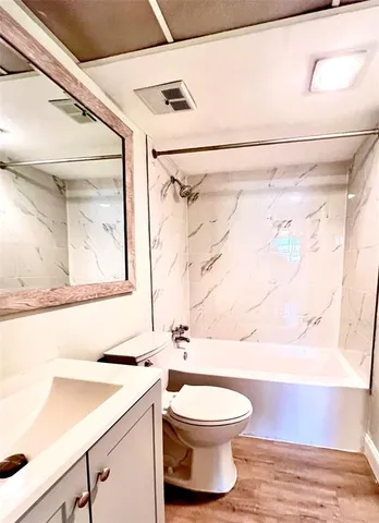 a bathroom with a toilet a sink and a shower