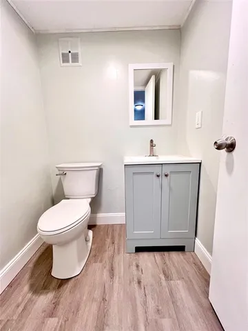 a bathroom with a toilet a sink and mirror