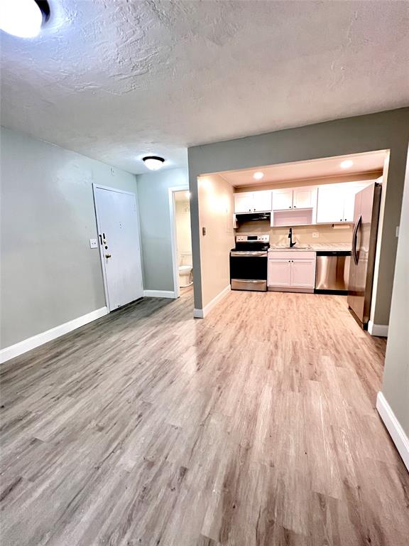 7000 Northwest 17th Street, Unit 109 Plantation, FL 33313 - Photo 8 of 21 an empty room with wooden floor fireplace and windows