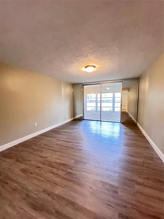 7000 Northwest 17th Street, Unit 109 Plantation, FL 33313 - Photo 10 of 21 wooden floor in an empty room with a window