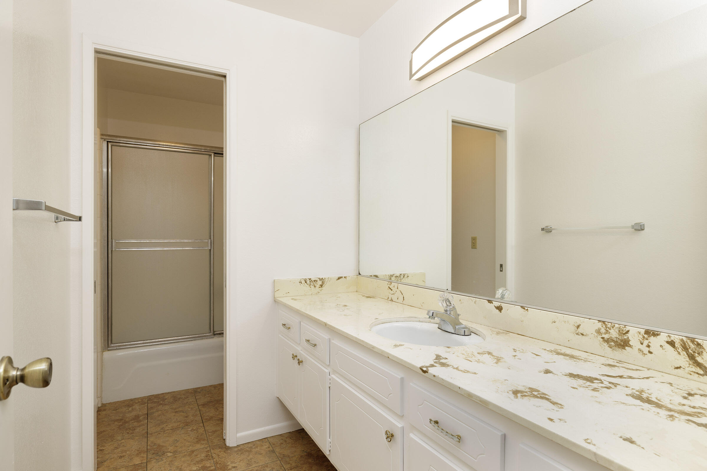 5121 Walnut Park Drive Santa Barbara, CA 93111 - Photo 21 of 23 a bathroom with a granite countertop sink and a mirror