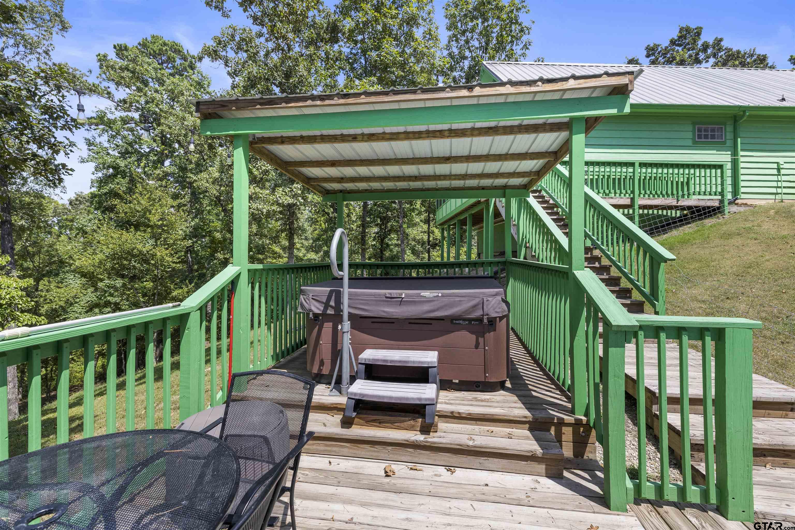 5066 Bob O Link Road Gilmer, TX 75645 - Photo 11 of 34 a view of a deck with wooden floor and outdoor seating