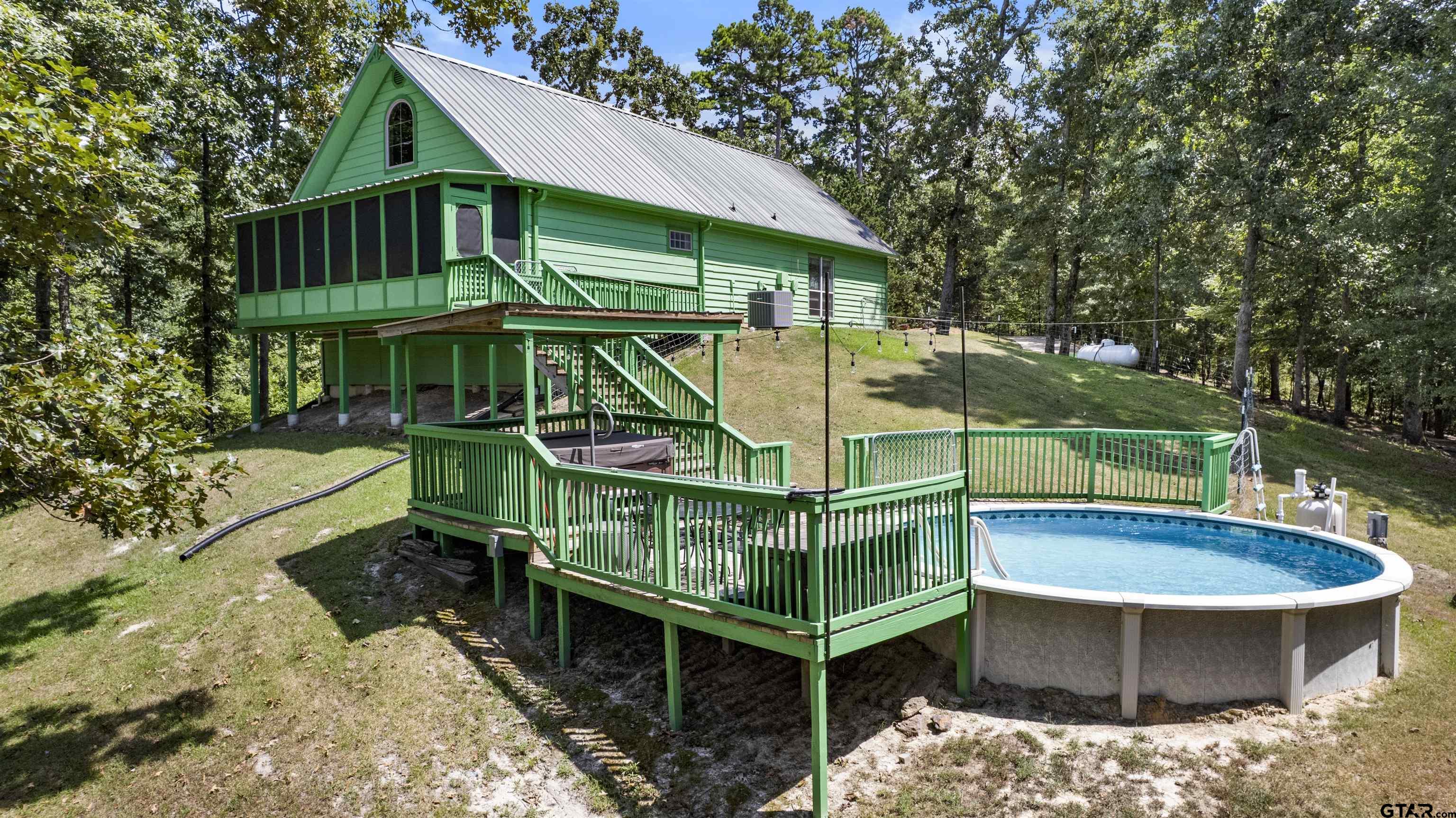 5066 Bob O Link Road Gilmer, TX 75645 - Photo 12 of 34 a view of a wooden deck with a patio