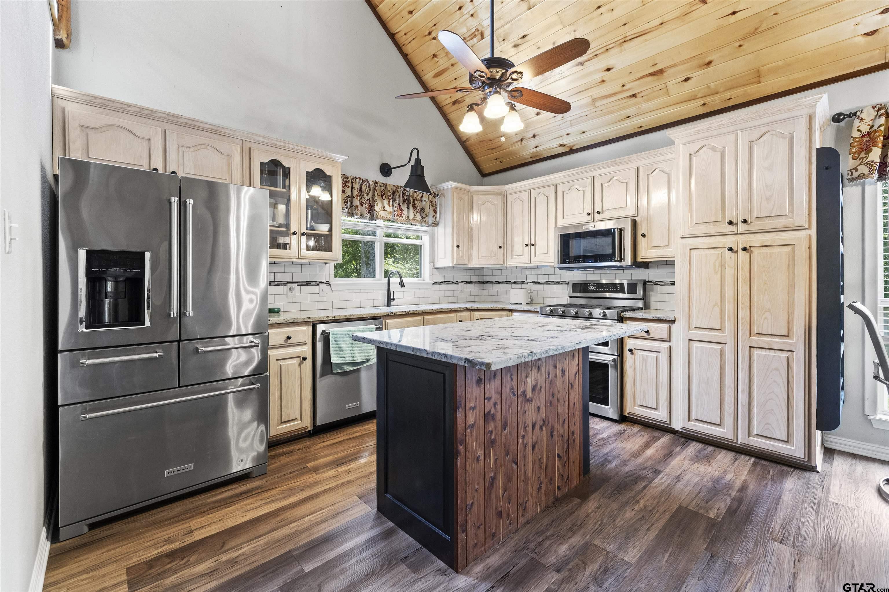 5066 Bob O Link Road Gilmer, TX 75645 - Photo 16 of 34 a kitchen with stainless steel appliances granite countertop a refrigerator stove and microwave