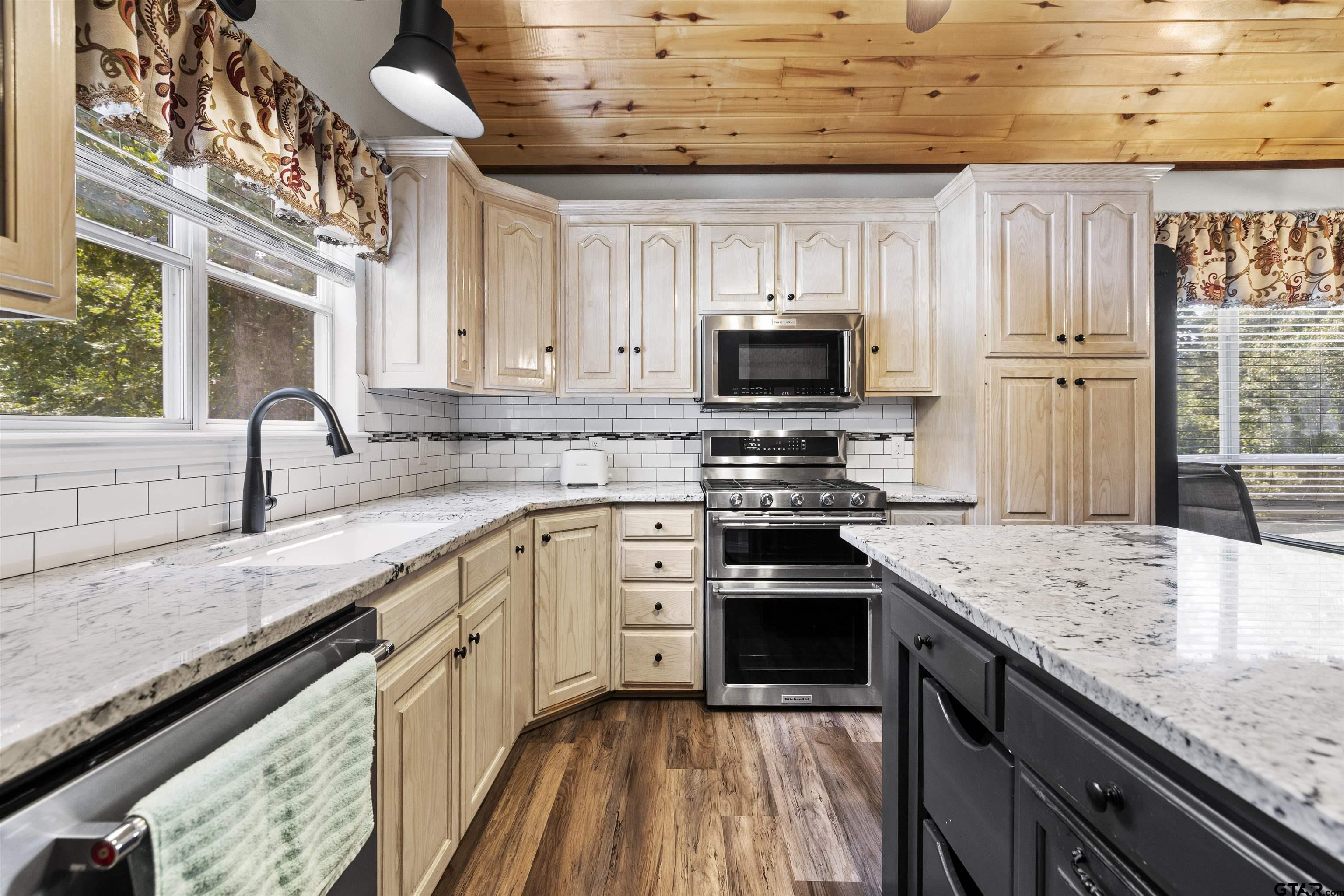 5066 Bob O Link Road Gilmer, TX 75645 - Photo 17 of 34 a kitchen with stainless steel appliances granite countertop a sink stove and refrigerator
