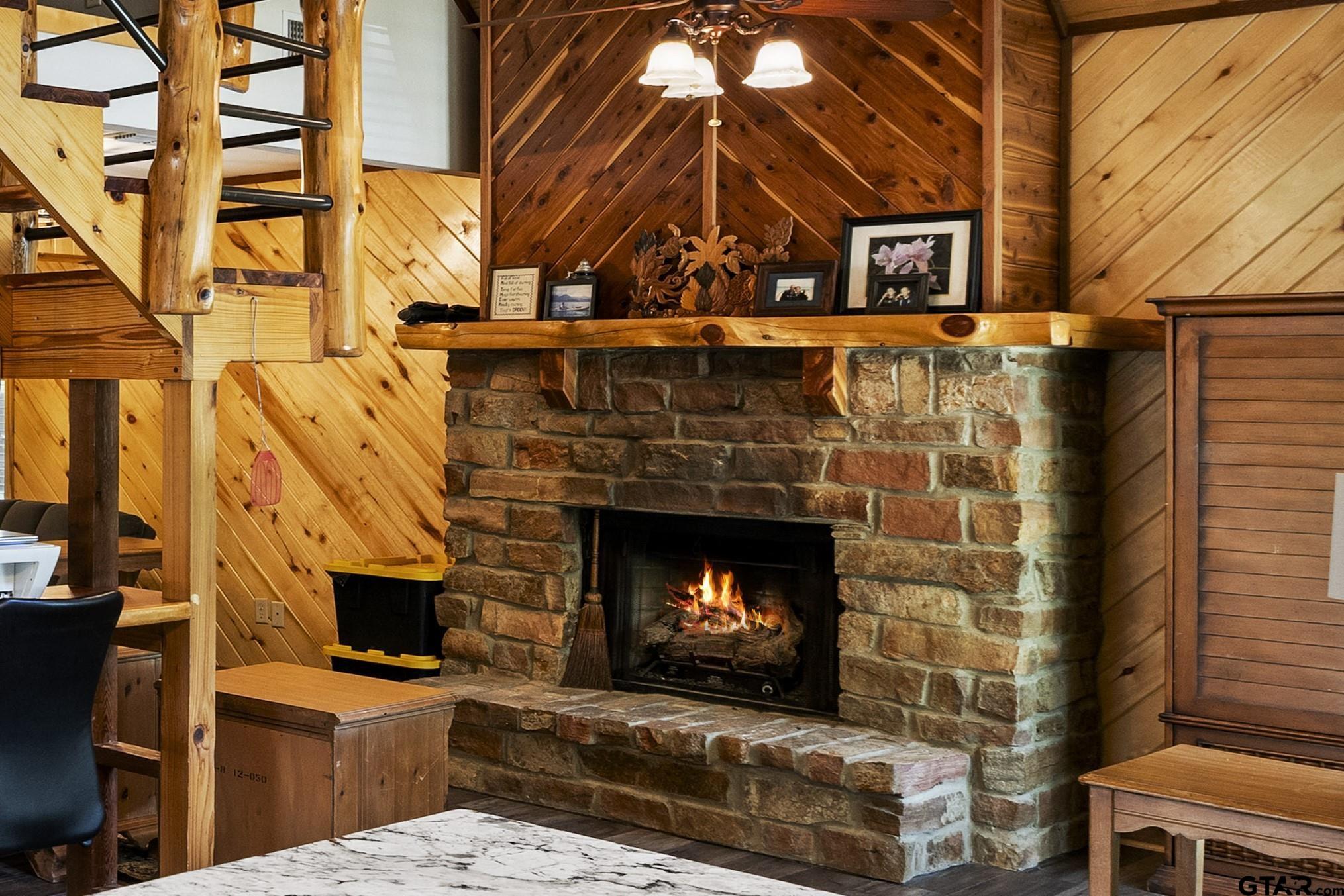 5066 Bob O Link Road Gilmer, TX 75645 - Photo 18 of 34 a living room with a fireplace a clock and a window