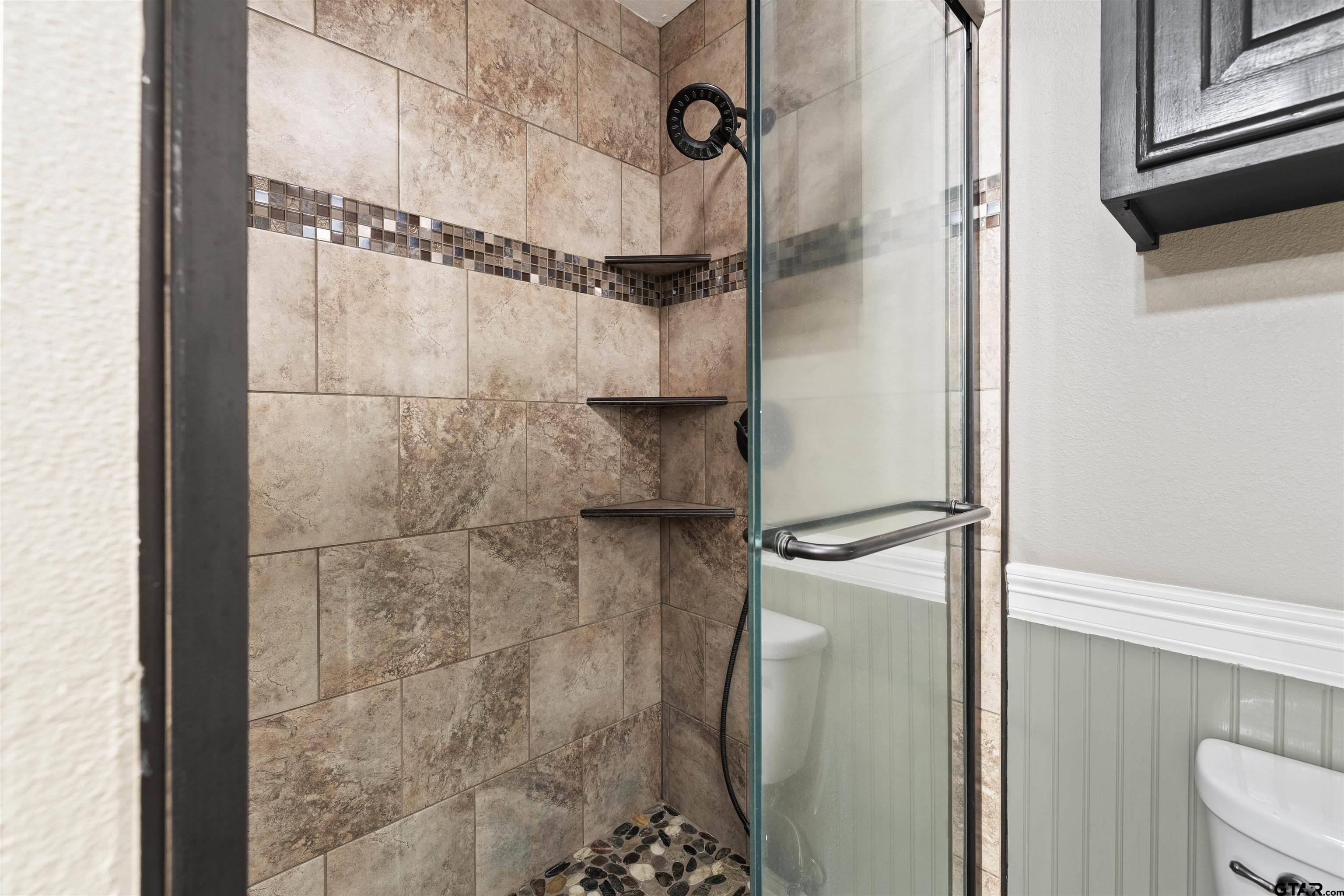 5066 Bob O Link Road Gilmer, TX 75645 - Photo 21 of 34 a bathroom with a glass shower door