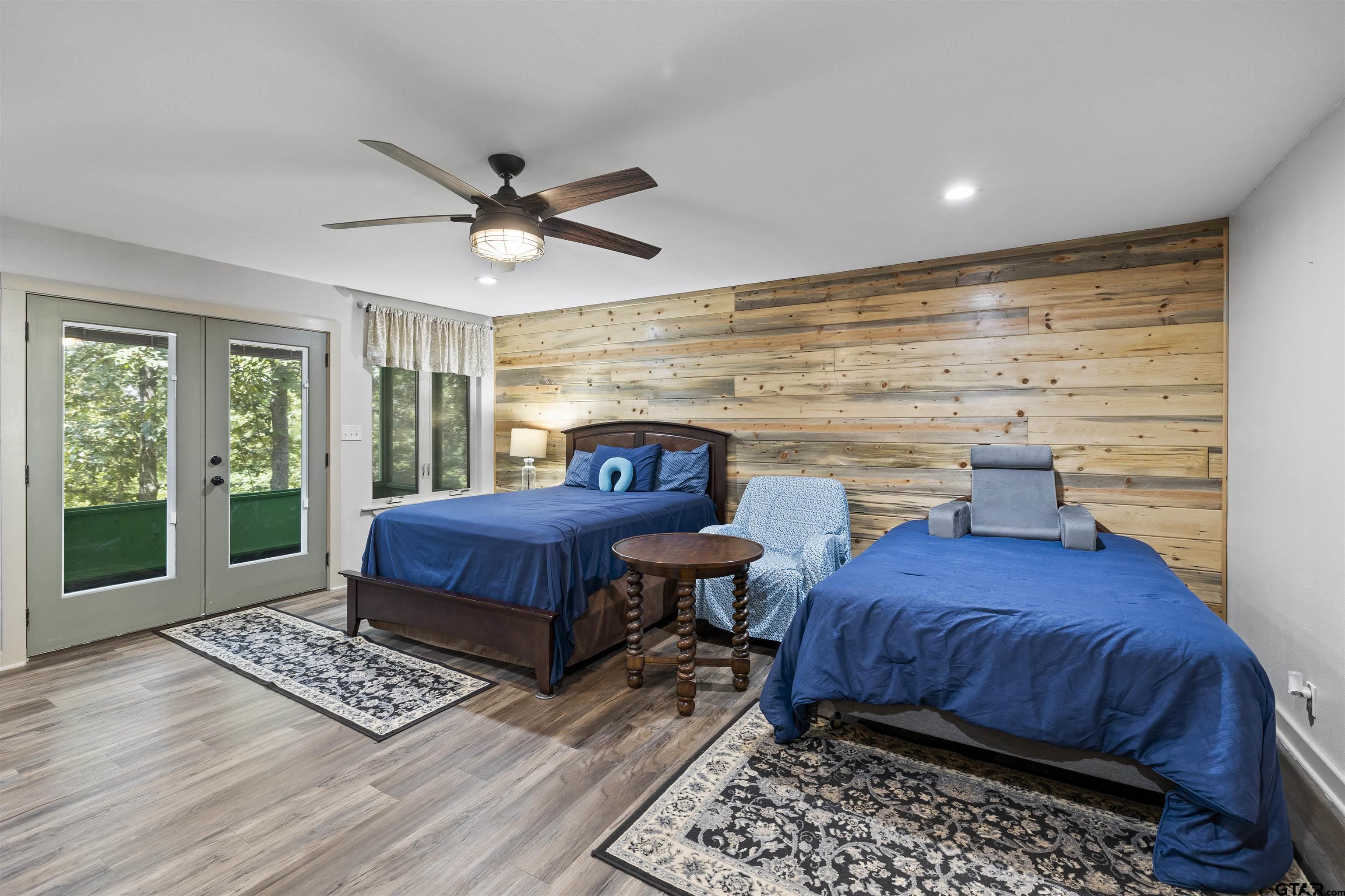 5066 Bob O Link Road Gilmer, TX 75645 - Photo 29 of 34 a bedroom with a bed and wooden floor