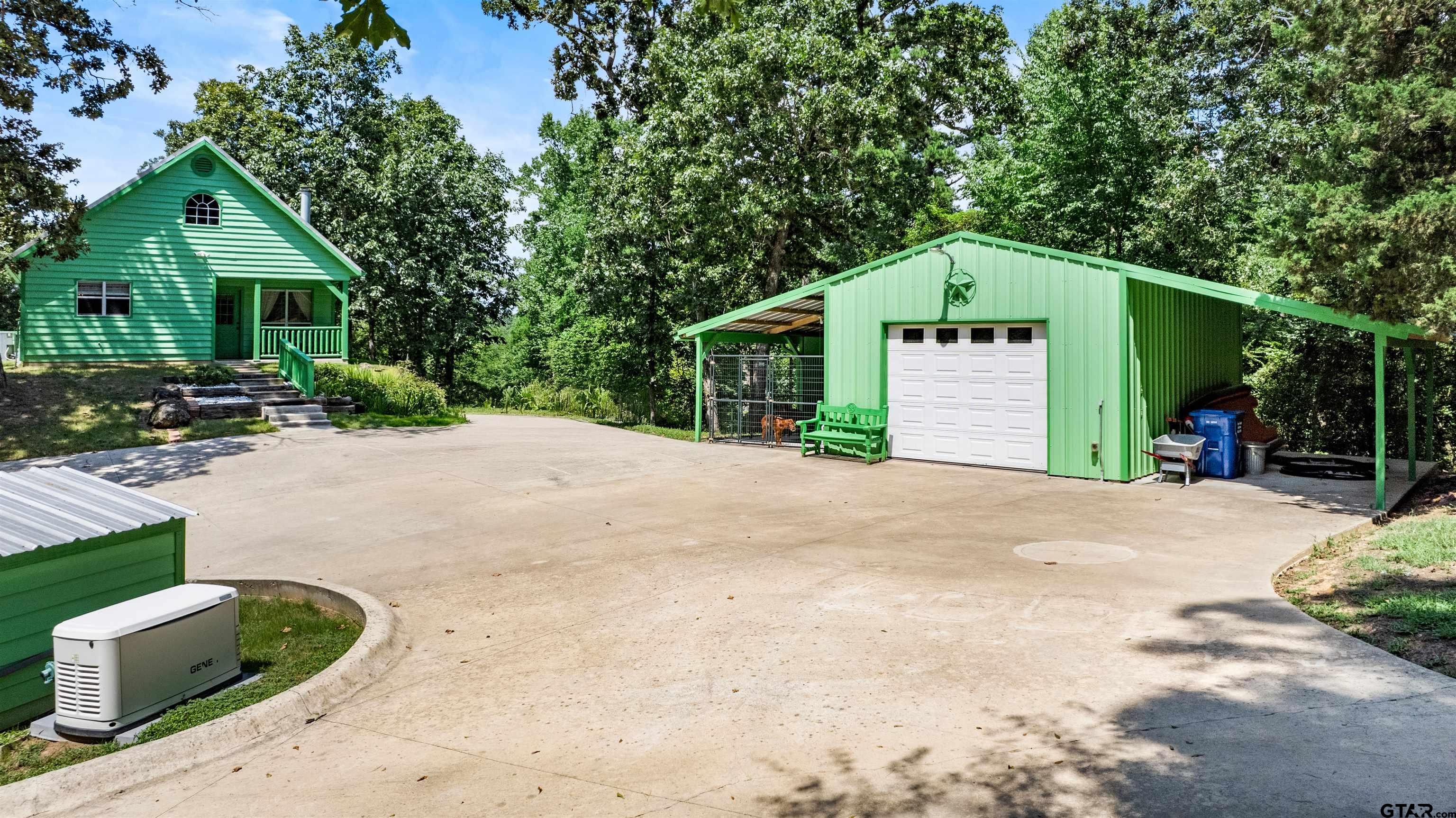 5066 Bob O Link Road Gilmer, TX 75645 - Photo 34 of 34 a front view of a house with a yard and garage