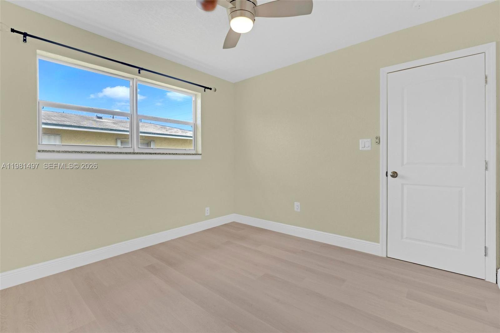 369 Phippen Waiters Road, Unit 2 Dania Beach, FL 33004 - Photo 17 of 18 a view of an empty room with a window