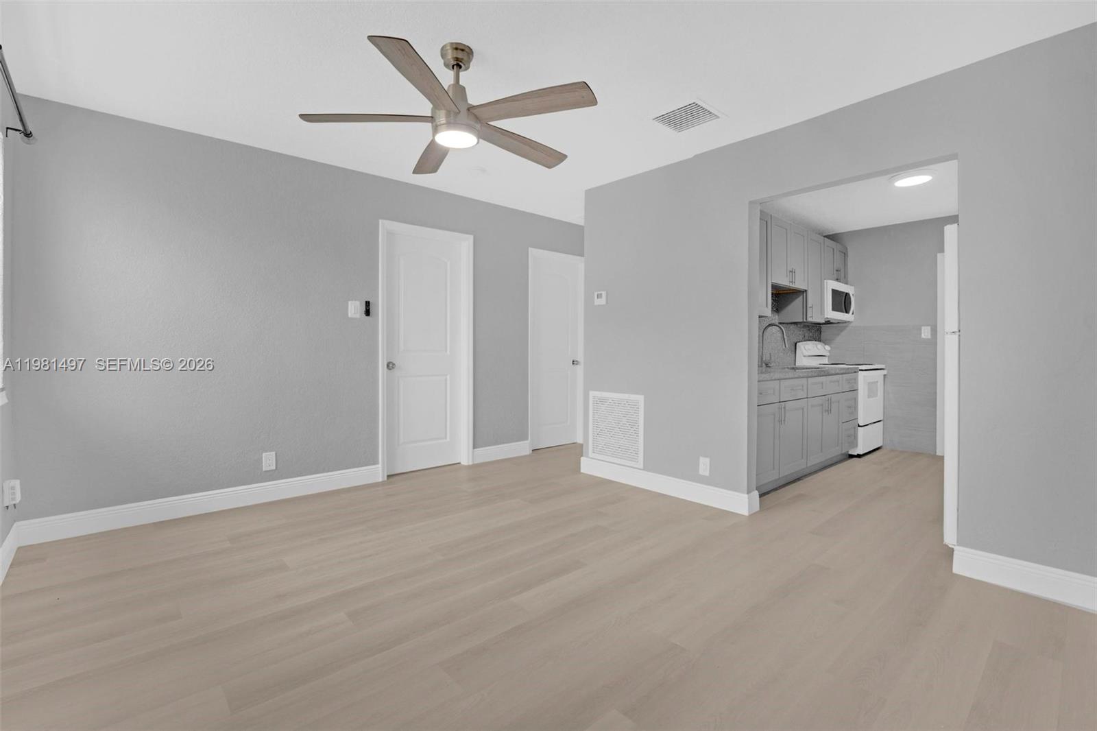 369 Phippen Waiters Road, Unit 2 Dania Beach, FL 33004 - Photo 4 of 18 a view of a kitchen with a sink and a refrigerator