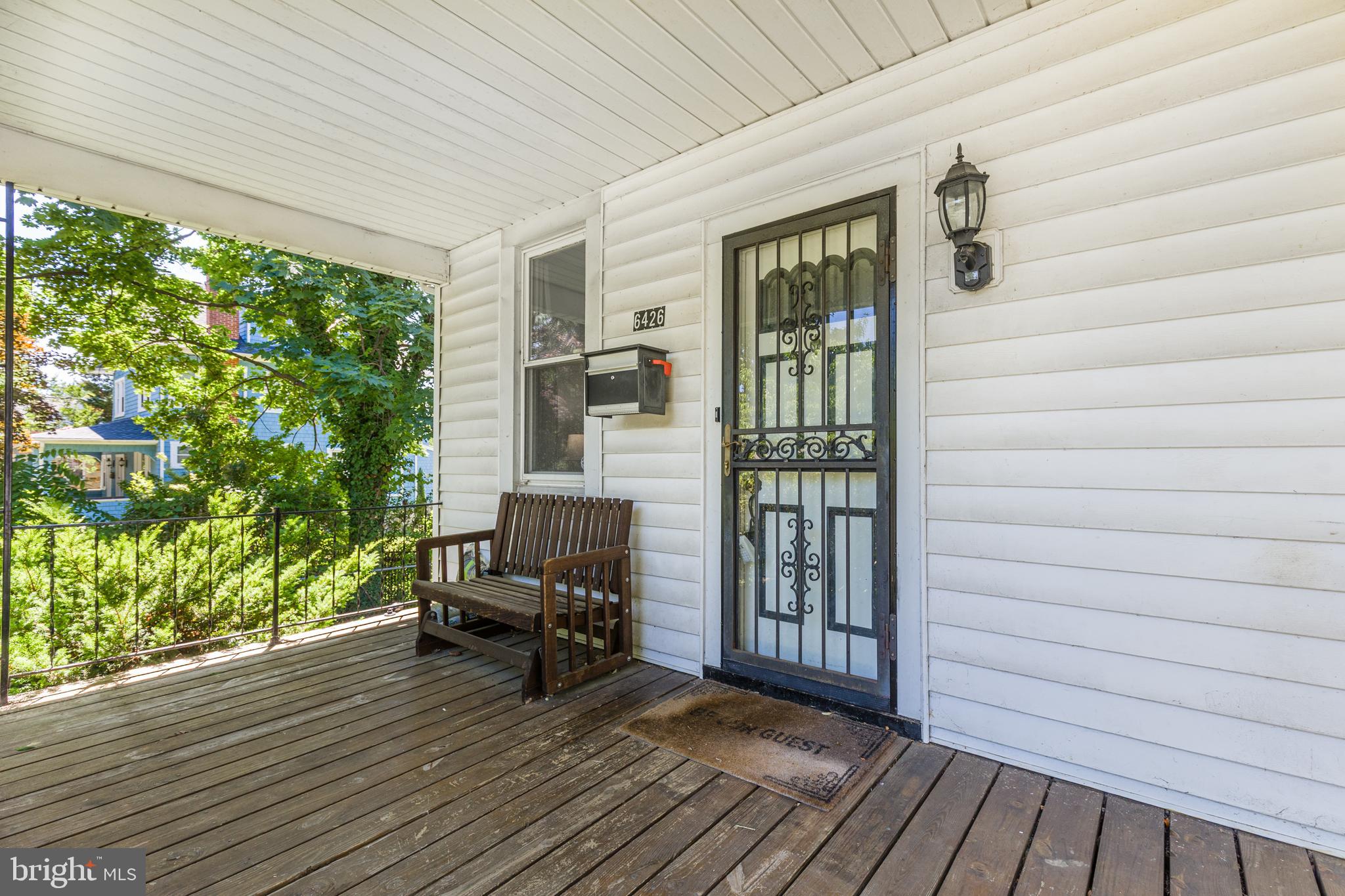 6426 Sherwood Road Baltimore, MD 21239 - Photo 3 of 43 a view of a balcony with furniture and floor to ceiling window