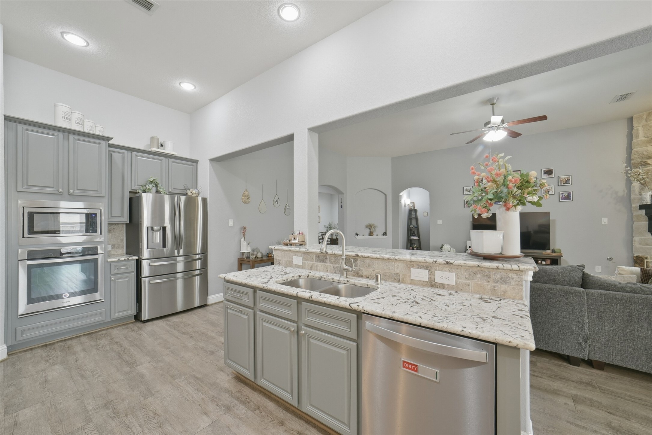 30014 Valley Terrace Drive Fulshear, TX 77406 - Photo 17 of 36 There is a double basin sink and stainless steel dishwasher located at the island.