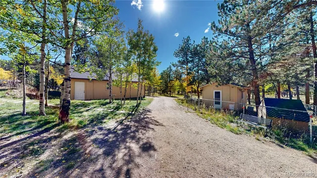 a wooden house with trees in front of it