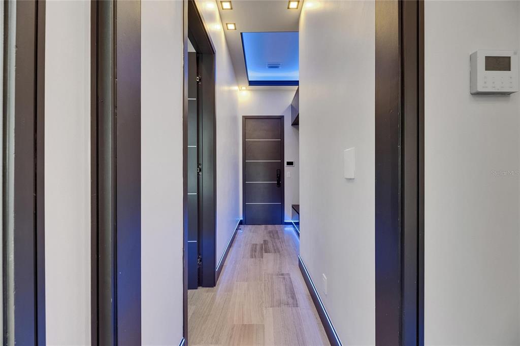 6528 Simone Shores Circle Apollo Beach, FL 33572 - Photo 51 of 98 a view of a hallway with wooden floor and staircase