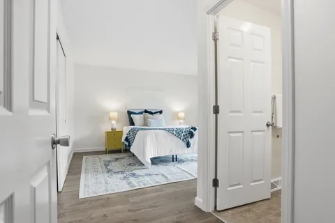 a bedroom with a bed and a mirror
