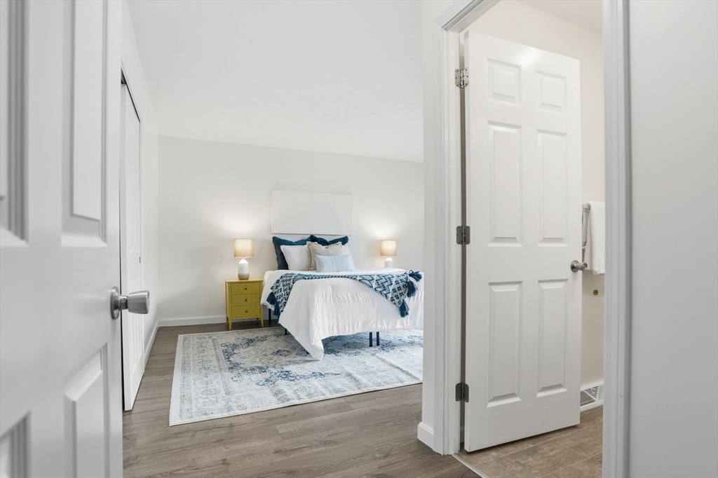 425 Main Street, Unit 22C Hudson, MA 01749 - Photo 13 of 23 a bedroom with a bed and a mirror
