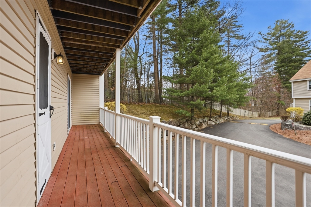 425 Main Street, Unit 22C Hudson, MA 01749 - Photo 17 of 23 a view of a pathway of a house with wooden deck
