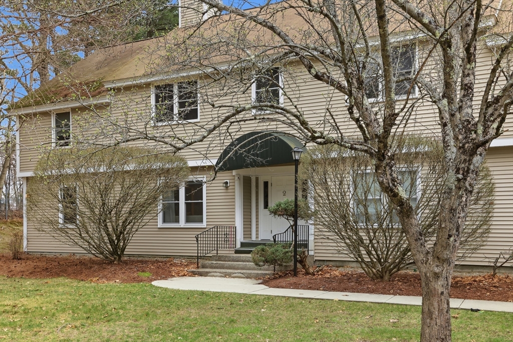 425 Main Street, Unit 22C Hudson, MA 01749 - Photo 18 of 23 a front view of a house with a yard