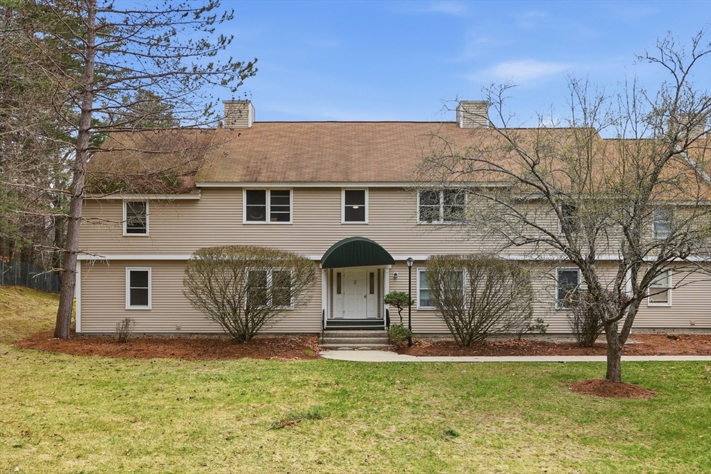 425 Main Street, Unit 22C Hudson, MA 01749 - Photo 20 of 23 a front view of a house with a yard