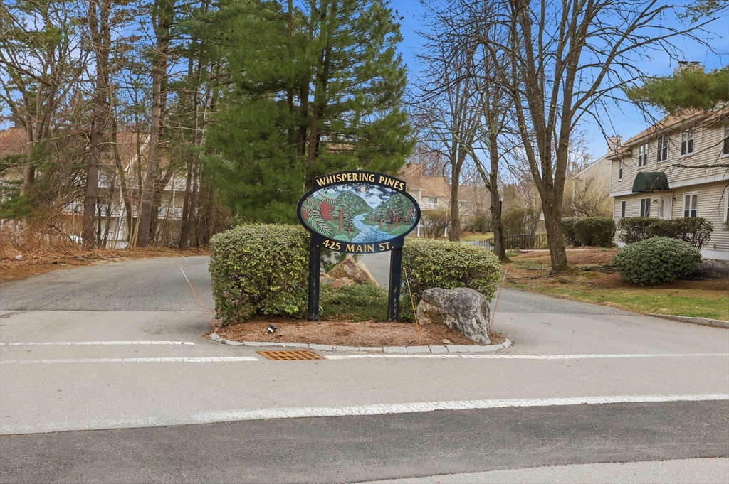 425 Main Street, Unit 22C Hudson, MA 01749 - Photo 23 of 23 a front view of a house with a yard garage and fountain