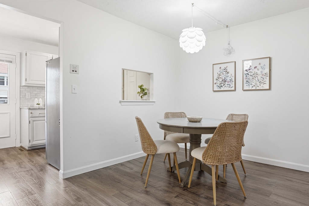 425 Main Street, Unit 22C Hudson, MA 01749 - Photo 4 of 23 a view of a dining room with furniture and wooden floor
