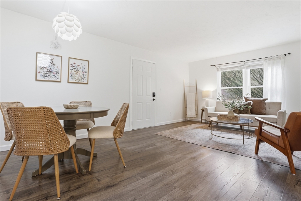 425 Main Street, Unit 22C Hudson, MA 01749 - Photo 5 of 23 a view of a dining room with furniture window and wooden floor