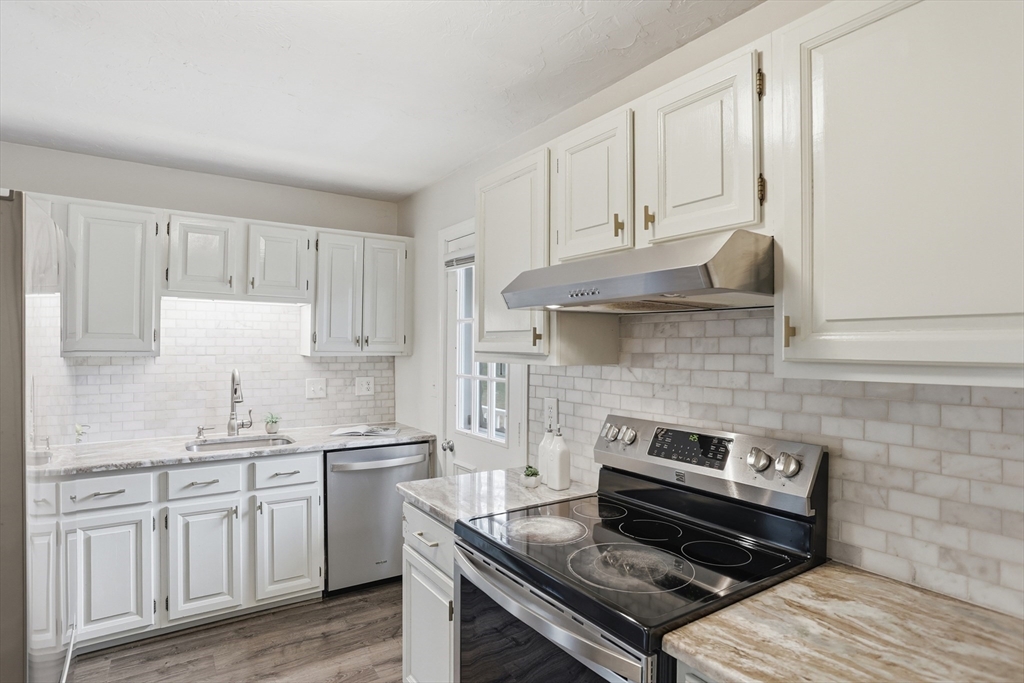 425 Main Street, Unit 22C Hudson, MA 01749 - Photo 6 of 23 a kitchen with appliances cabinets and a counter top space