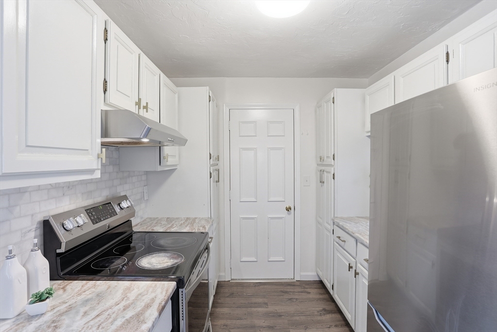 425 Main Street, Unit 22C Hudson, MA 01749 - Photo 8 of 23 a kitchen with cabinets and a stove top oven