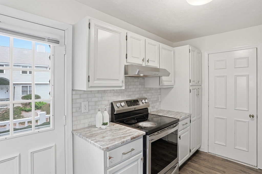425 Main Street, Unit 22C Hudson, MA 01749 - Photo 10 of 23 a kitchen with a stove and a white cabinet