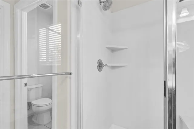 a bathroom with a toilet and a vanity