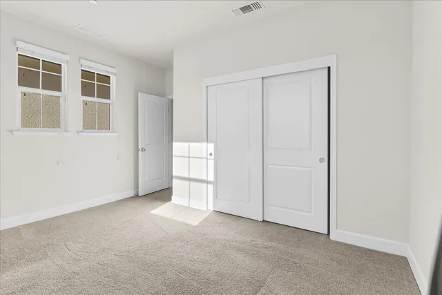 a view of an house with backyard and patio