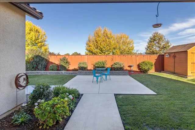 a backyard of a house with outdoor seating